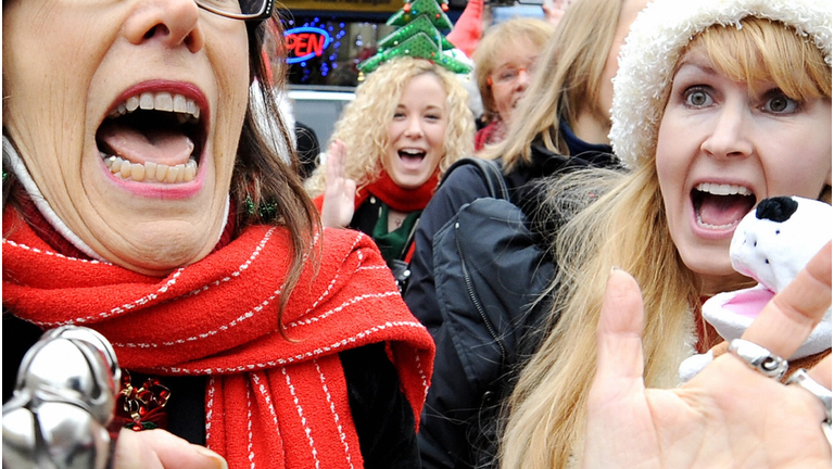 Volunteers sings Christmas carols as peo