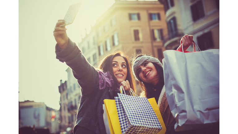 Women take a selfie during christmas shopping in Rome