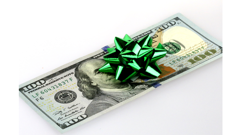 Gift bow decorating a gift of US cash