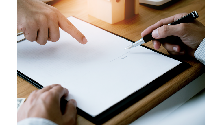 Cropped Finger Pointing At Blank Paper To Man In Office