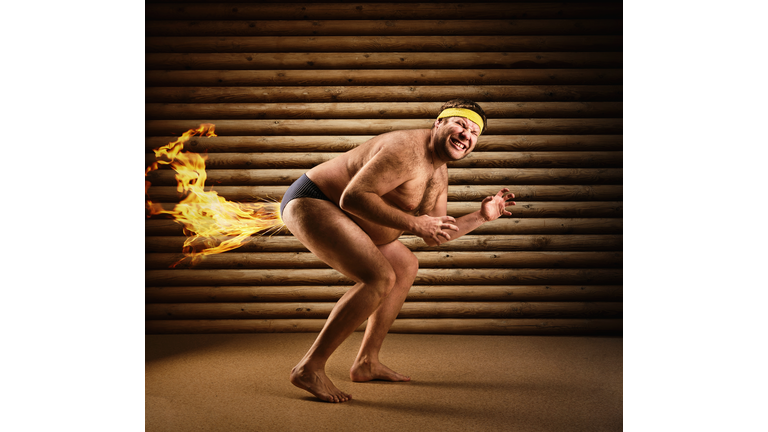 Very strange naked man farts by fire