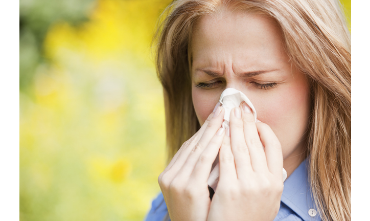 Close up of woman sneezing