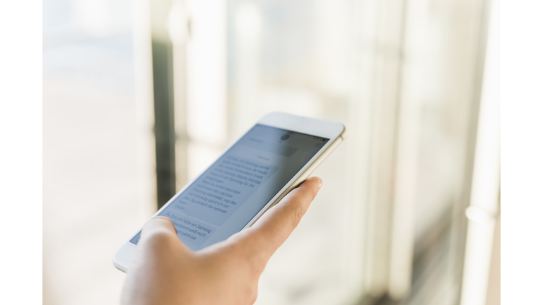 Close-up of businesswoman texting on cell phone