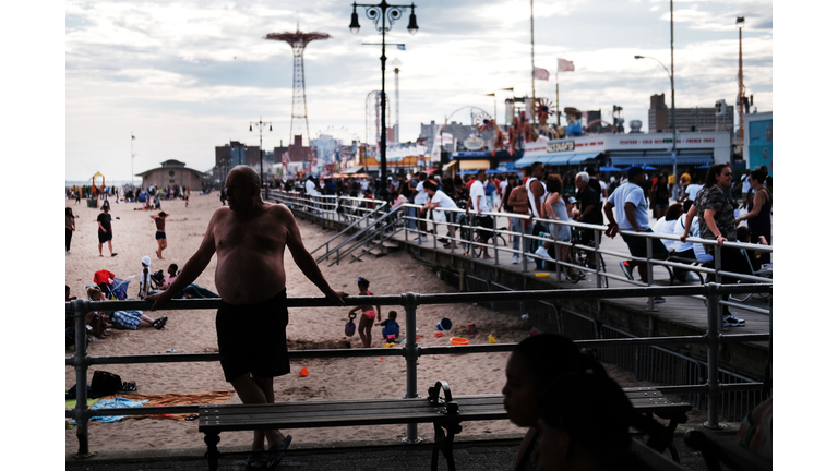 Crowds Flock To Coney Island Beach And Boardwalk On Warm Weekend