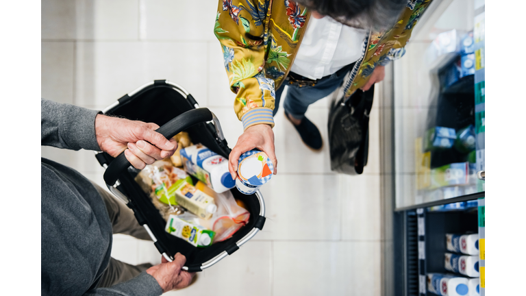 Aerial View Of Senior Couple Picking Out Groceries