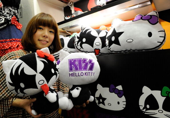 An employee for Japanese character goods maker Sanrio displays Hello Kitty dolls designed like the US rock band KISS, at Sanrio's headquarters in Tokyo on February 7, 2012. Sanrio, which collaborated on the products with the band, will put them on sale in the near future. (YOSHIKAZU TSUNO/AFP via Getty Images)