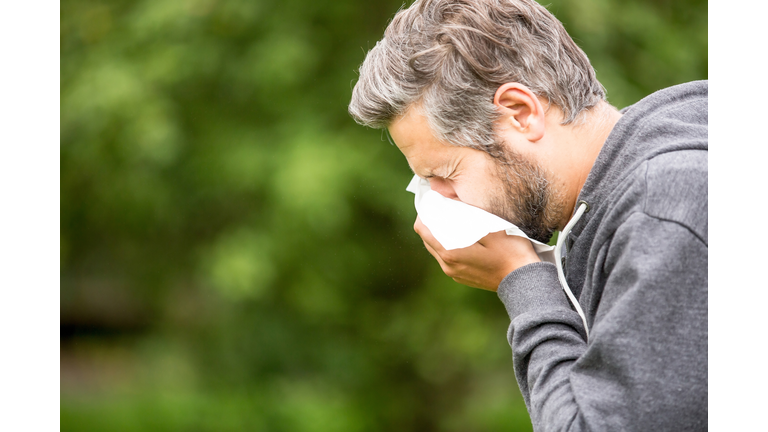 Man Sneezing By Tree