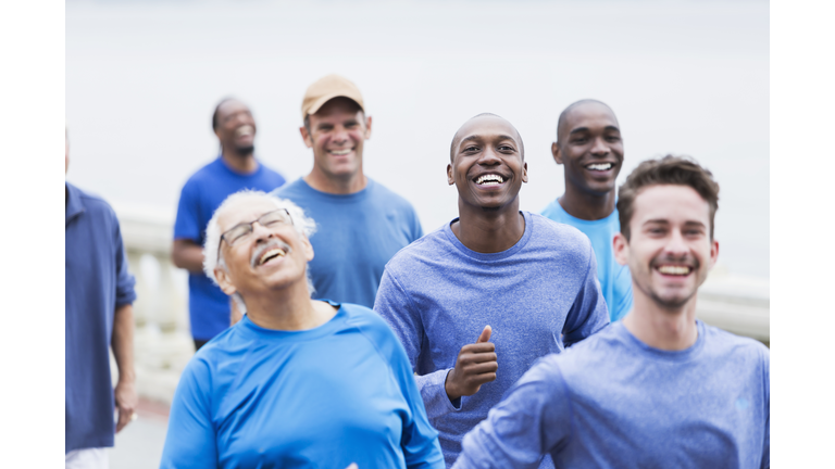 Multi-racial group of men wearing blue shirts