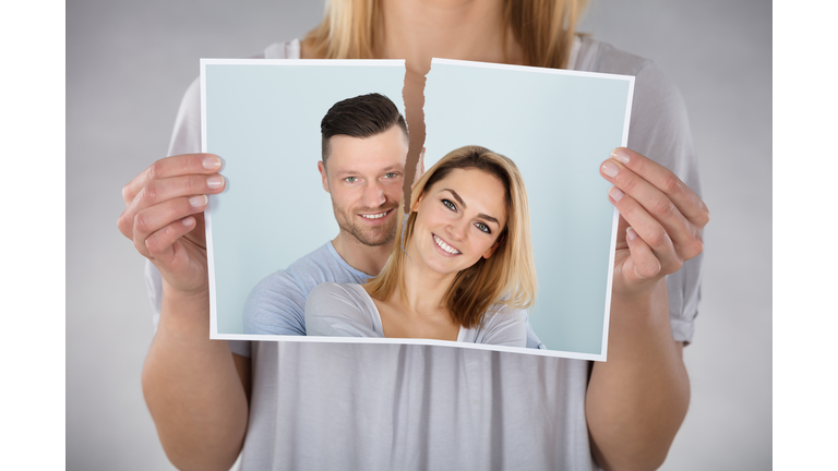 Woman Tearing Photo