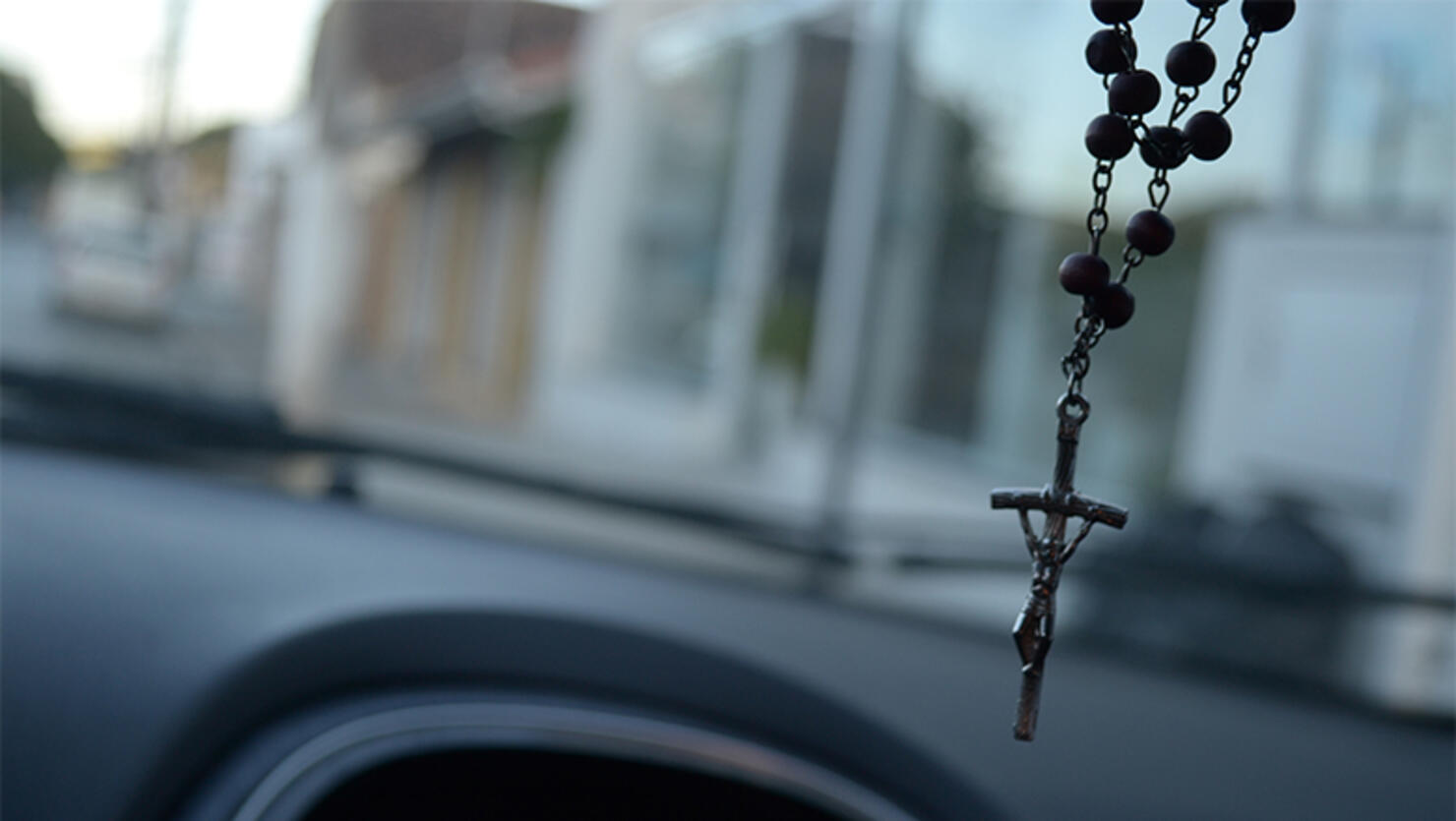 Close-Up Of Crucifix Hanging In Car
