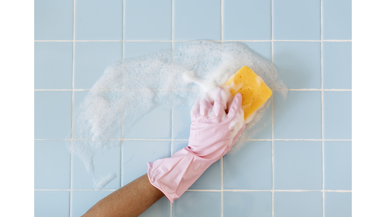 Hand in pink glove with sponge washing
