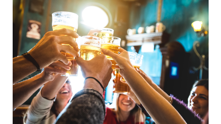 Friends Toasting Beer In Restaurant