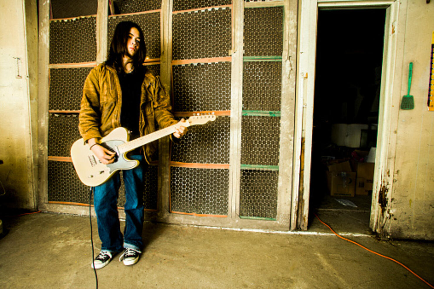 Mixed Race man playing electric guitar outdoors