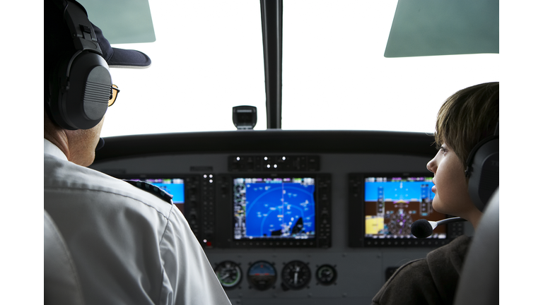 Young boy in the cockpit of a small seaplane.