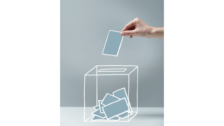 Young woman's hand voting