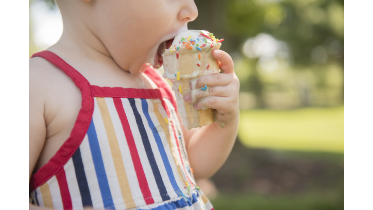 Baby girl (18-23 months) eating ice-cream