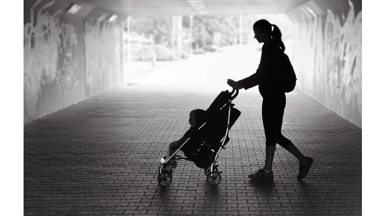 Woman walking with her son in the city