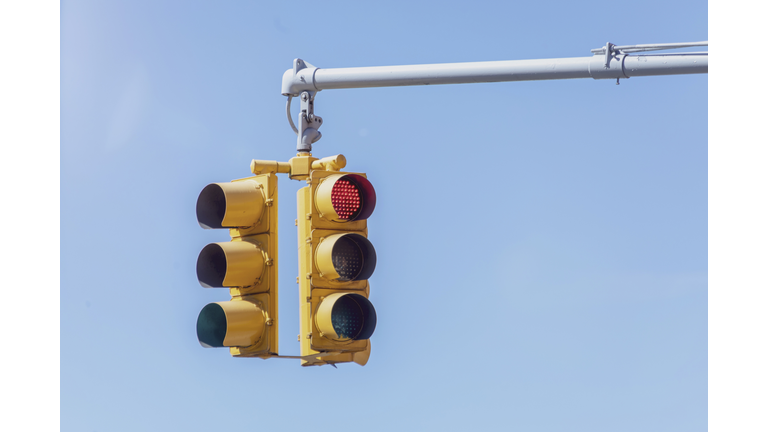 Traffic lights against blue sky.