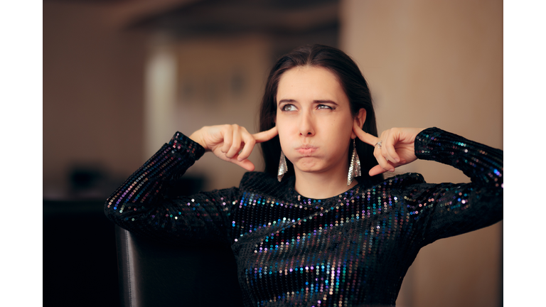 Unhappy Girl Hating the Loud Bad Music at a Party