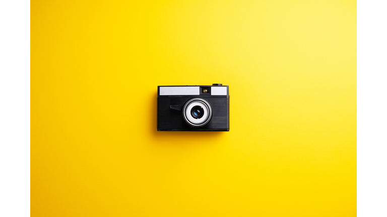 Close-Up Of Camera On Colored Background