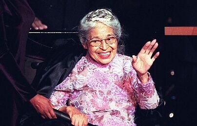 Civil rights icon Rosa Parks waves to the audience