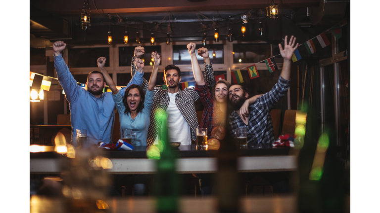 Fans at the bar celebrating together