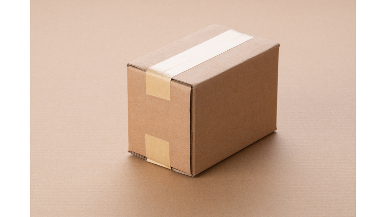 Single Cardboard Box on Brown Paper