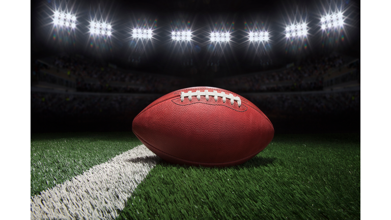 Close-Up Of American Football On Field At Night