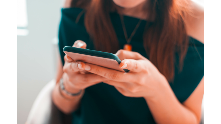 A young woman is using her smartphone