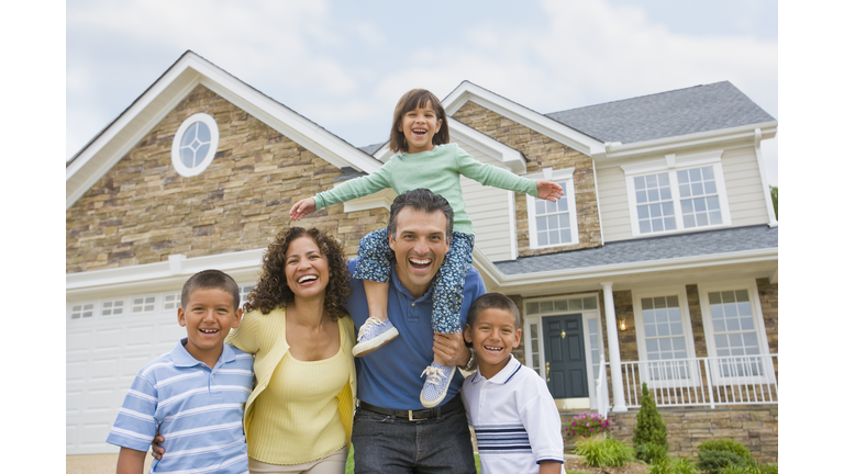 Hispanic family in front of house