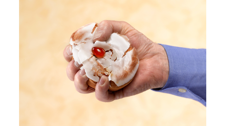 Male dieter crushing belgian bun