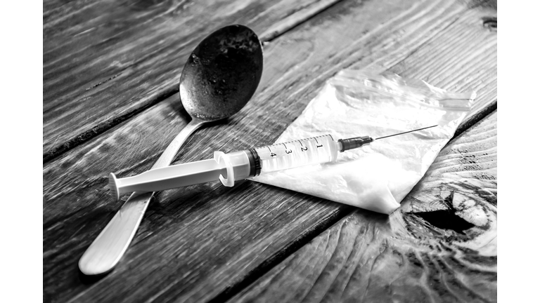 Close-Up Of Narcotics With Syringe And Spoon On Table