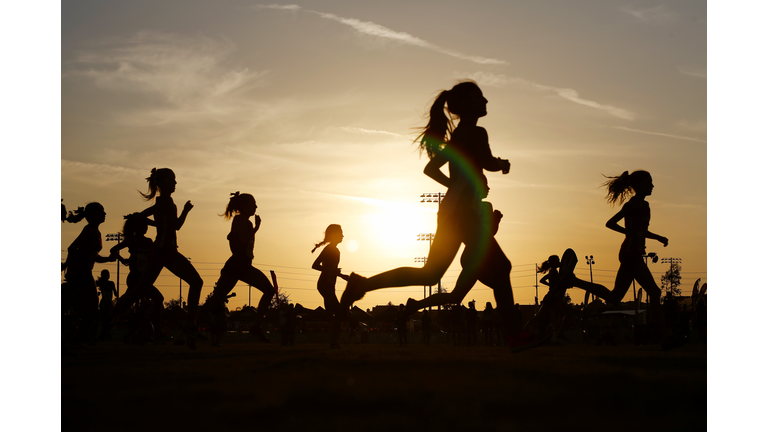 Runners compete in a 5k at sunset in Corona, California.