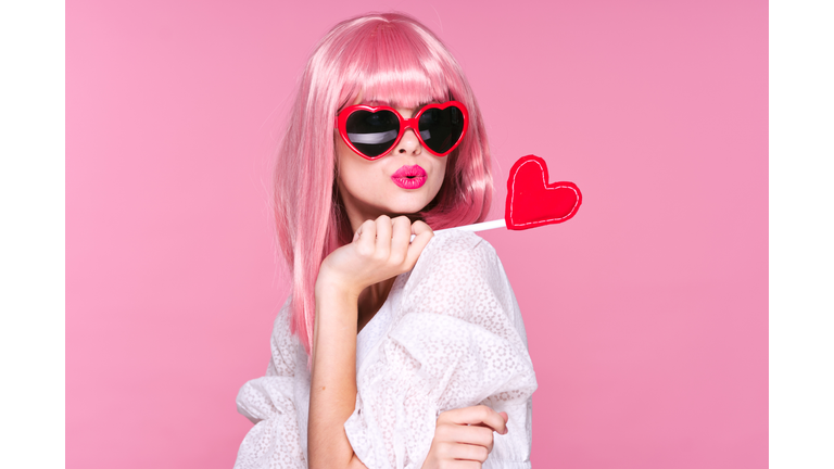 Woman with heart in hand, Valentine's day, glasses hearts and pink background