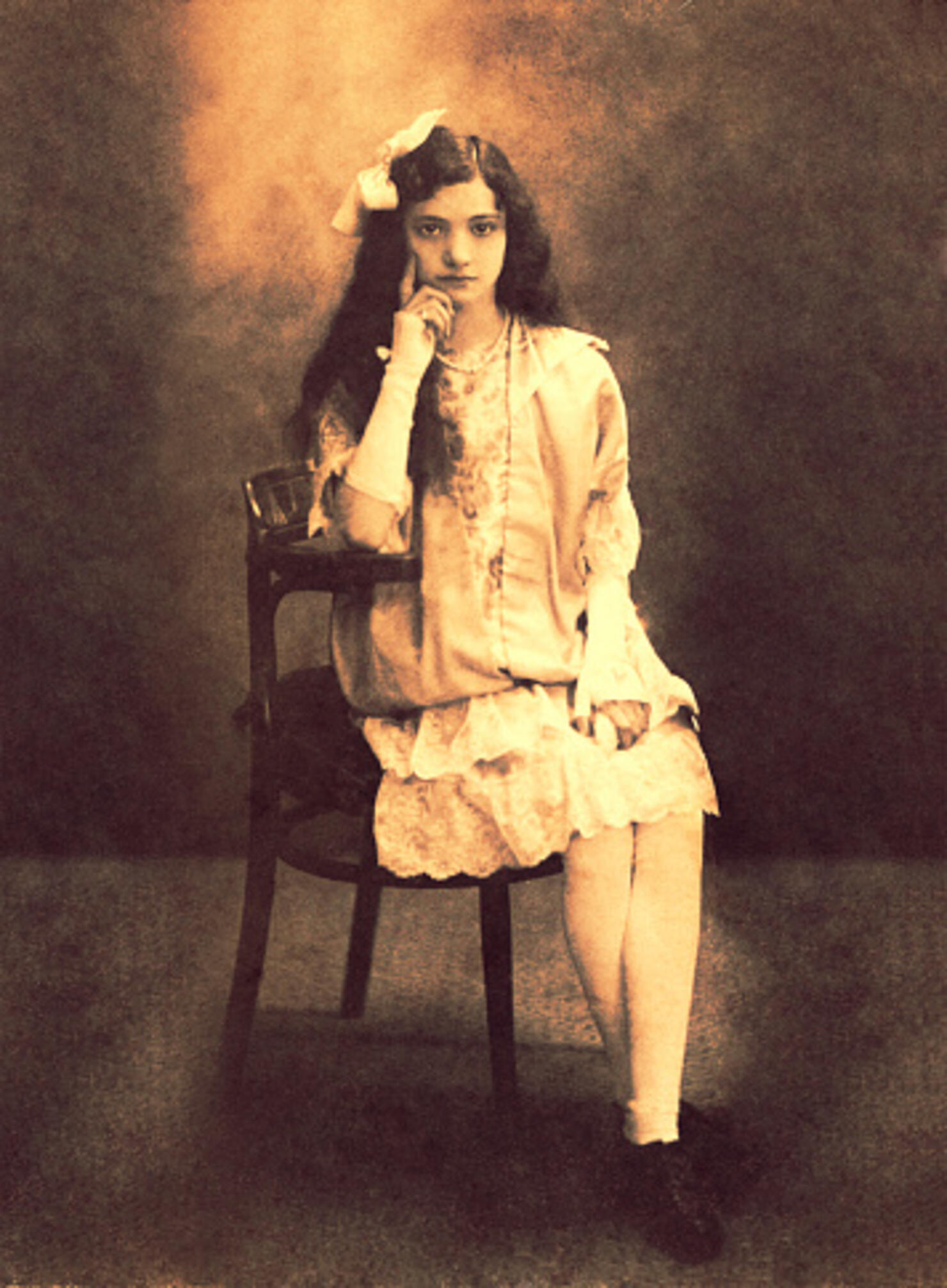 Vintage girl sitting in front of the camera