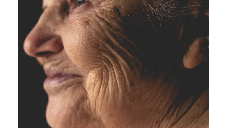 Wrinkled face of elderly woman, smiling details