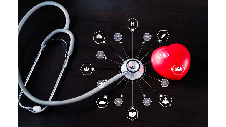 Medicine. Stethoscope with red heart and icon medical network connection on wooden. virtual technology concept.