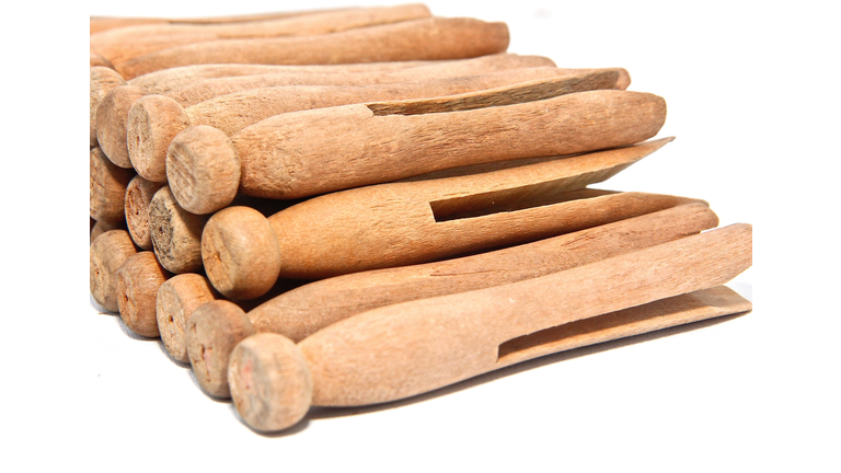 Stack Of Old-Fashioned Clothespins On White Background