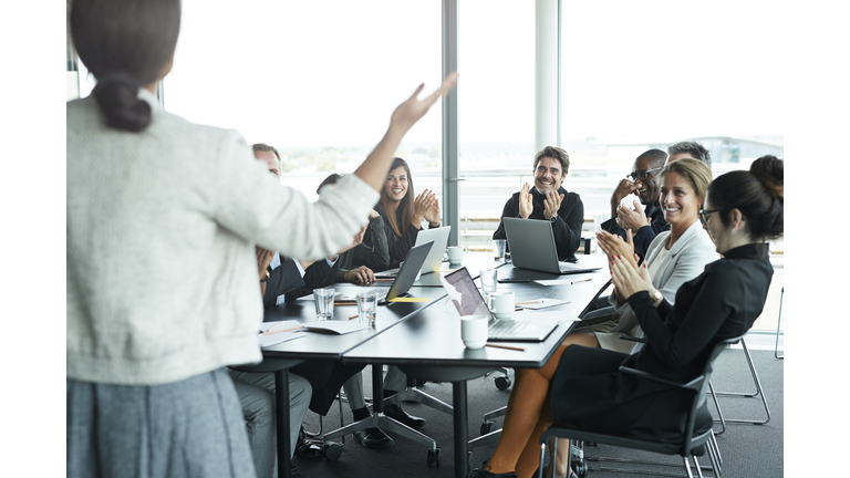 Businesswoman doing presentation in big boardroom