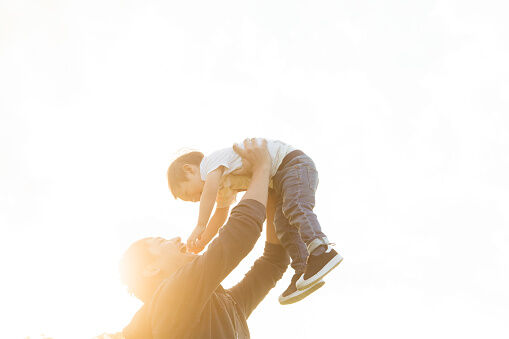 A father lifting his son