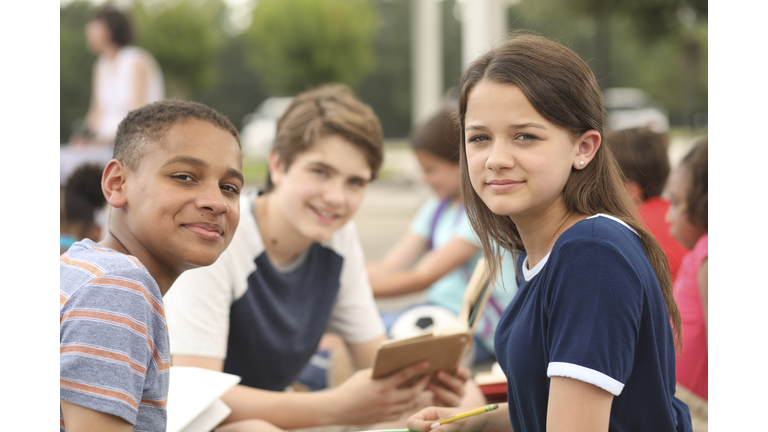 Group of junior high school children, teenage friends studying on campus.