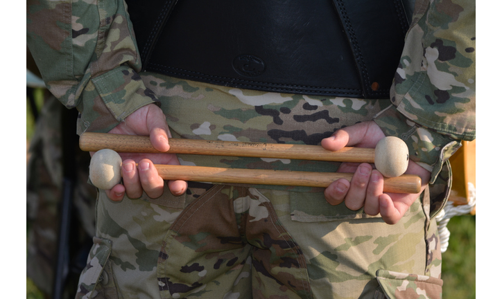 Military Band Plays on Graduation Day, drummer holds mallets behind his back.