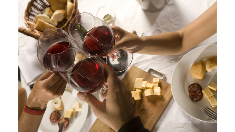 Close-up of three friends toasting with wine, Montevideo, Uruguay