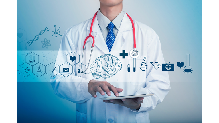 Midsection Of Doctor Holding Digital Tablet