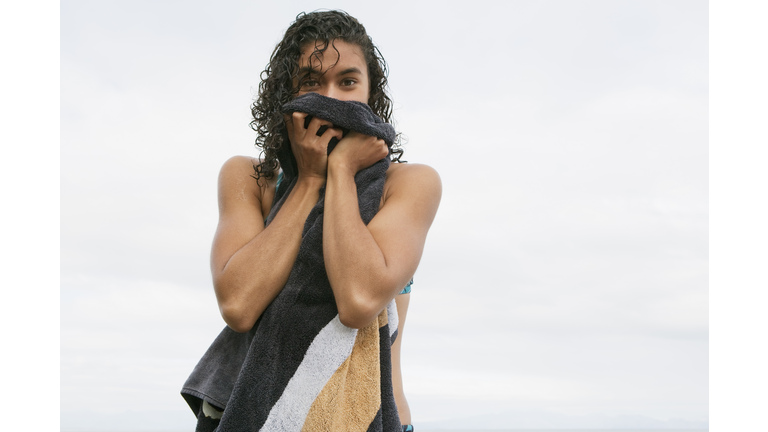Woman toweling off on beach