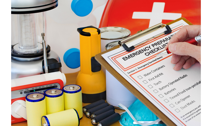 Hand completing Emergency Preparation List by Equipment