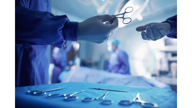 Handing doctor surgical tool in operating room