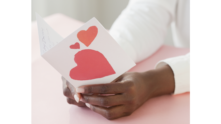 African woman holding Valentine's Day card