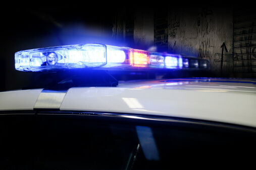 Lights on top of police car lit up at night