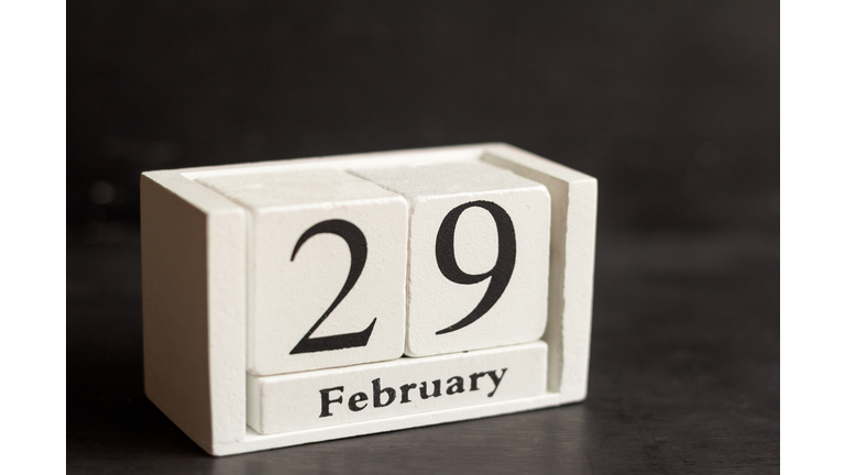 February 29 on a wooden calendar on a dark background .Calendar date, holiday event, or birthday.The last day of the winter month. February 29 happens every four years.